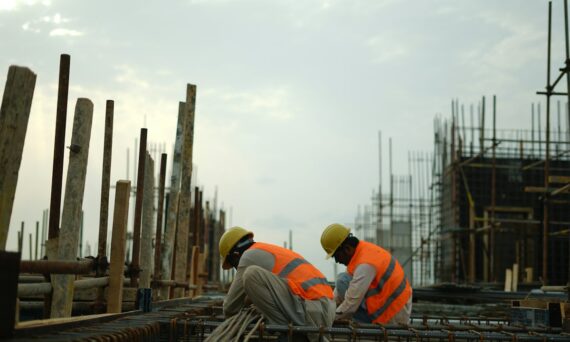 Construction workers in hard hats and safety vests on site